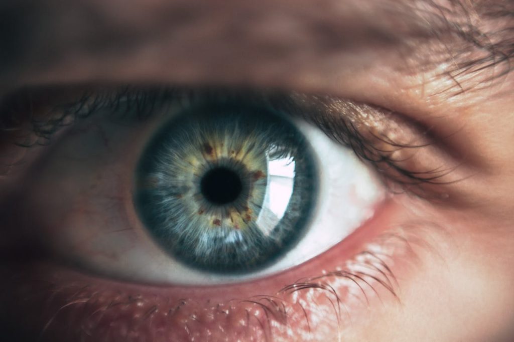 Detailed macro image capturing the intricacies of a human eye, showcasing color and texture.